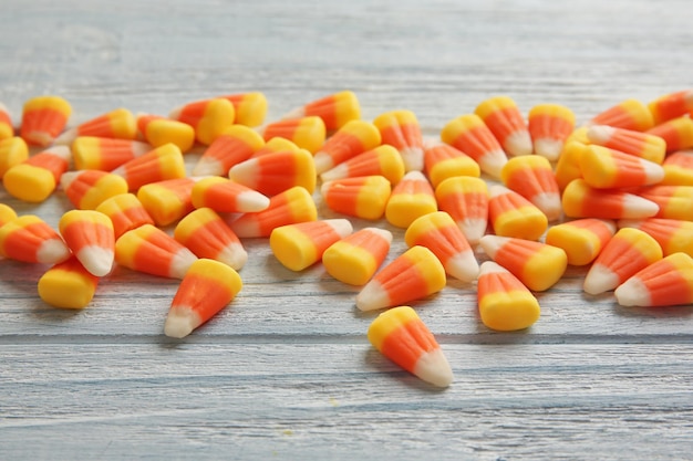 Premium Photo | Colorful halloween candy corns on wooden background