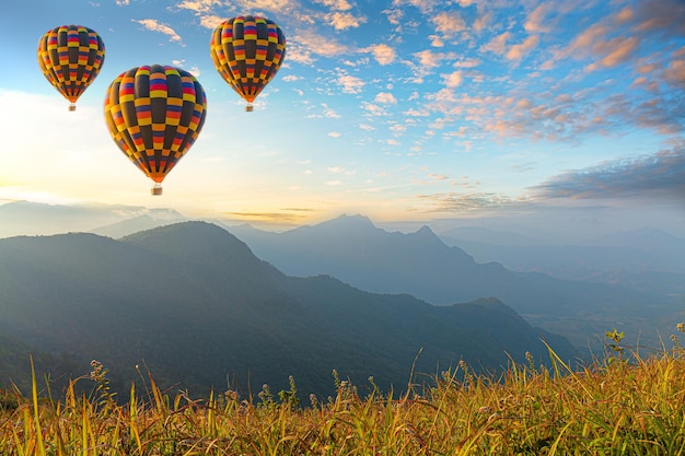 Premium Photo | Colorful hot air balloons flying over mountain at dot ...