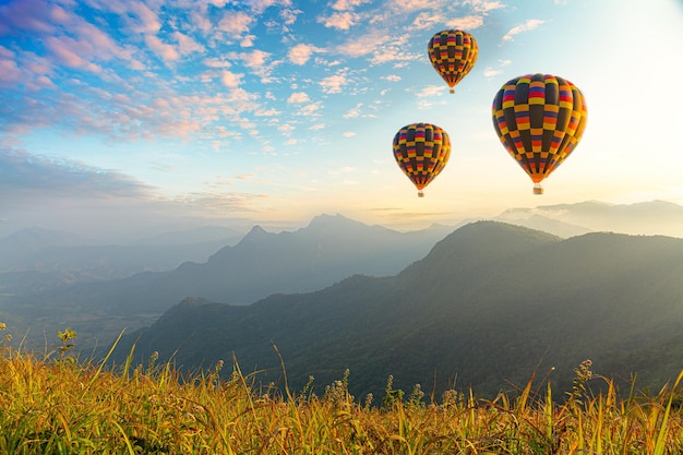 Premium Photo | Colorful hot air balloons flying over mountain at dot ...