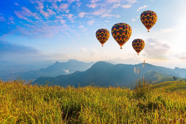 Premium Photo | Colorful hot air balloons flying over mountain at dot ...