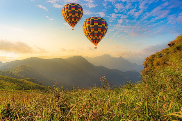 Premium Photo | Colorful hot air balloons flying over mountain at dot ...