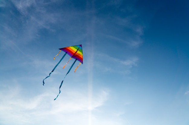 Premium Photo | Colorful kite flying on the clear blue sky.