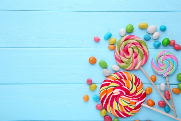 Premium Photo | Colorful lollipops and different colored round candy on ...