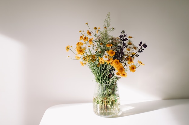 Premium Photo | Colorful midsummer bunch of wildflowers in a vase on ...