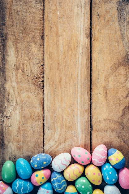 Premium Photo | Colorful pastel easter eggs on wooden background with ...