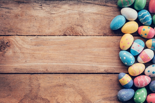 Premium Photo | Colorful pastel easter eggs on wooden background with ...