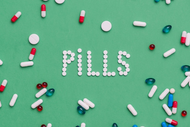 Free Photo | Colorful pills on green background