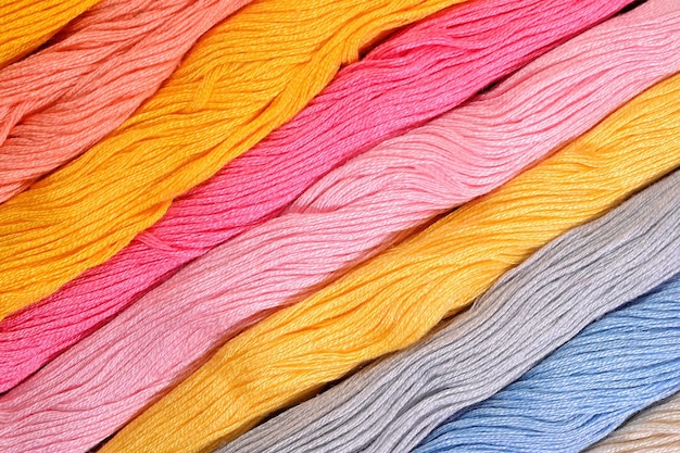 Premium Photo | Colorful skeins of floss as background texture close up