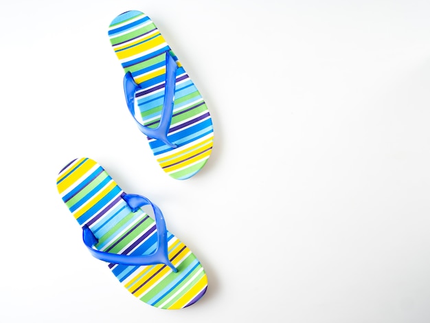 Colorful striped flip flops on white background Premium Photo
