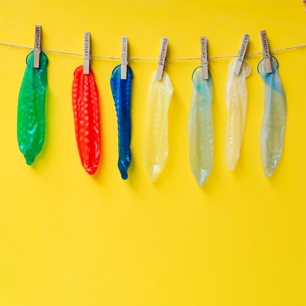 Free Photo | Colourful condoms hanging on clothesline