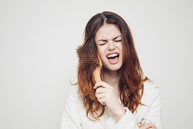 Premium Photo | Comb stuck in the hair of an emotional woman