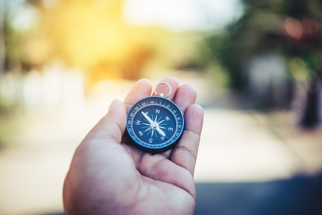 Premium Photo | Compass in the hand. tourists hold a compass and locate ...