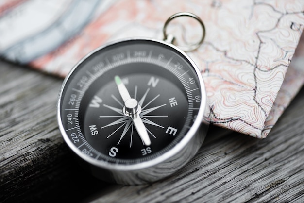 Premium Photo | Compass and map on a beautiful wooden surface. top view