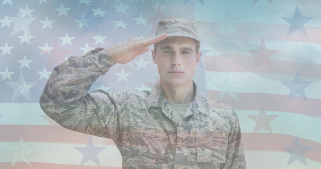 Premium Photo | Composition of male soldier saluting over american flag