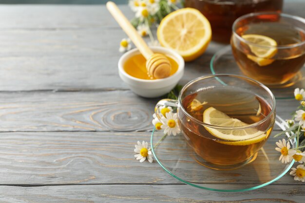 Premium Photo | Composition with chamomile tea on gray wooden background