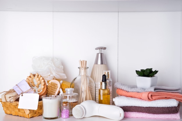 Composition with spa cosmetic, candles and brush for face, isolated on white Premium Photo