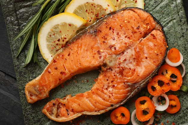 Premium Photo | Composition with tasty grilled salmon on wooden ...