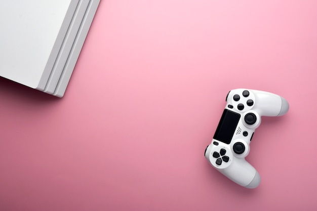 Computer game player. gaming concept. white joystick and conor of computer on pink background. Premium Photo