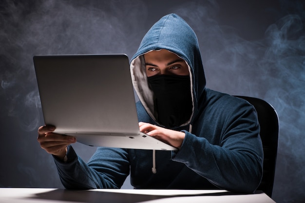 Computer hacker working in dark room Photo | Premium Download