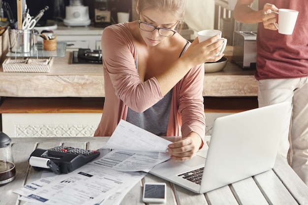 Free Photo | Concentrated woman dressed casually calculating bills ...