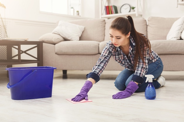 Premium Photo | Concentrated woman polishing wooden floor