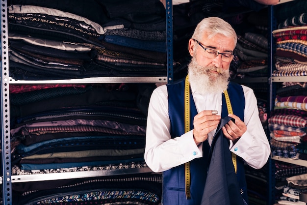 Concentrated young male fashion designer at work in a studio Free Photo