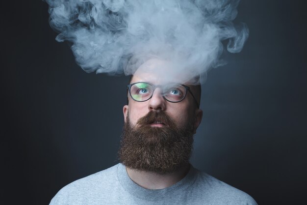 Premium Photo | Concept. smoke enveloped the head man. portrait of a ...