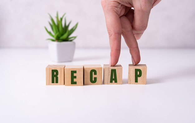 Premium Photo | The concept of the word recap on cubes on a beautiful