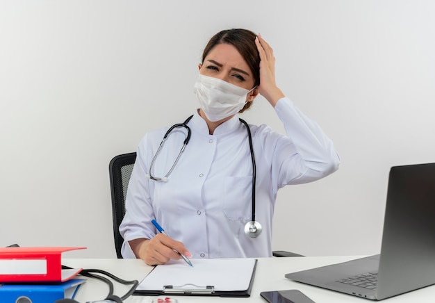 Free Photo Concerned Young Female Doctor Wearing Medical Robe With