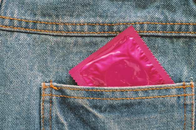 Premium Photo | Condom in back of pocket blue jean