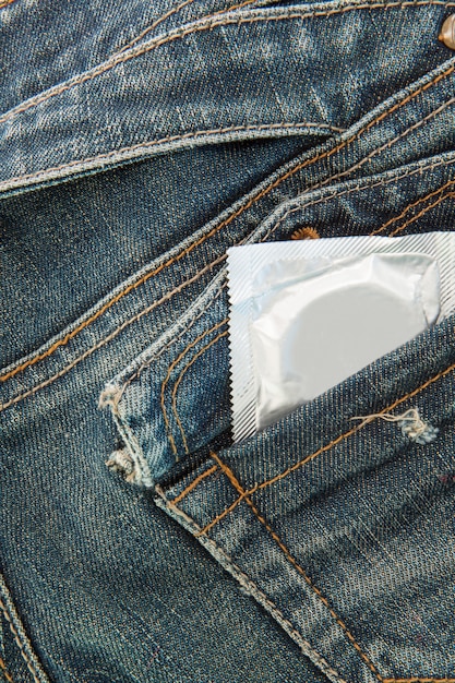 Premium Photo | Condom in jeans pocket