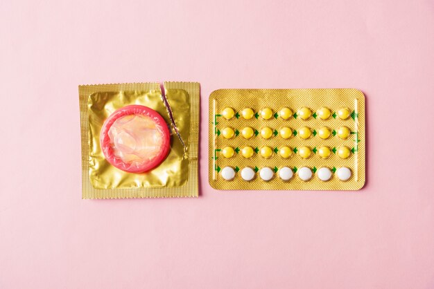 Premium Photo | Condom on wrapper pack and contraceptive pills blister