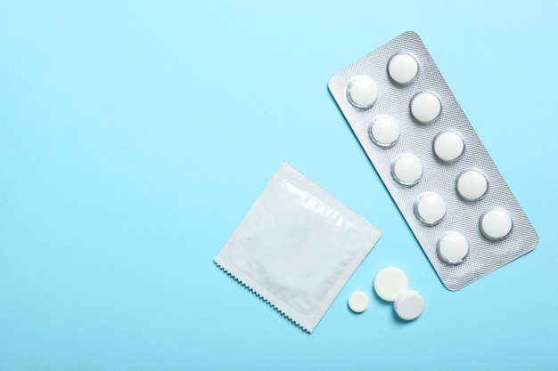 Premium Photo | Condoms and other contraceptives on a colored background