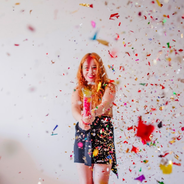 Confetti flying in air and girl behind | Free Photo
