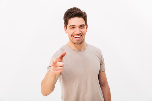 Confident cheerful man with brown hair gesturing index ...