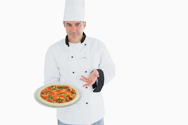 Premium Photo | Confident chef displaying pizza