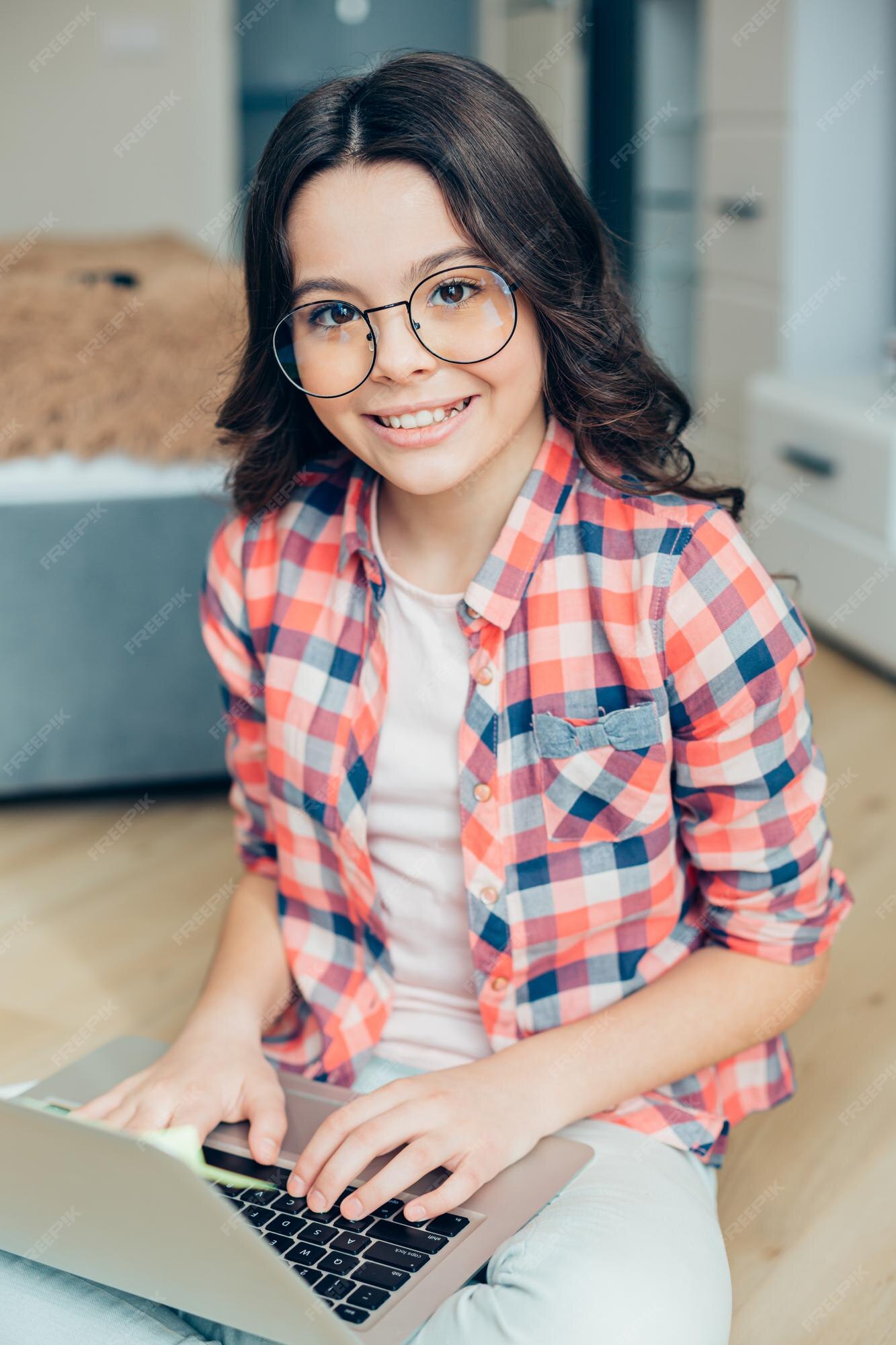 Premium Photo | Confident clever girl in round spectacles sitting on ...