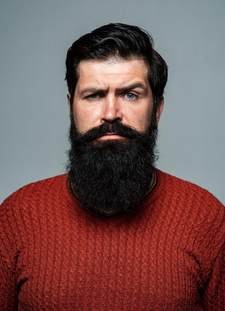 Premium Photo | Confident man has beard and mustache, looks seriously ...