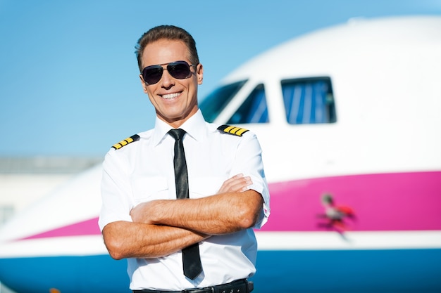 Premium Photo | Confident pilot. confident male pilot in uniform ...