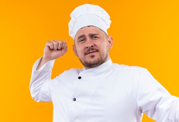 Free Photo | Confident young handsome cook in chef uniform with raised ...