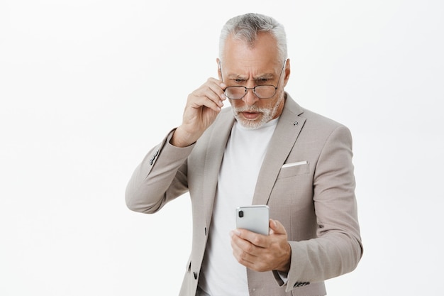 Free Photo Confused Serious Looking Elderly Businessman Looking At