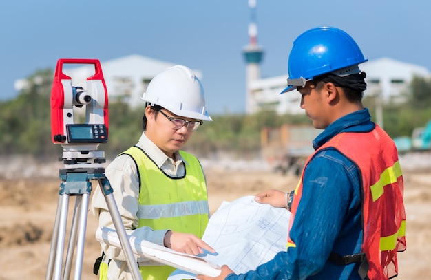 Construction engineer and foreman worker checking construction drawing at site for new infrastructure construction project Premium Photo