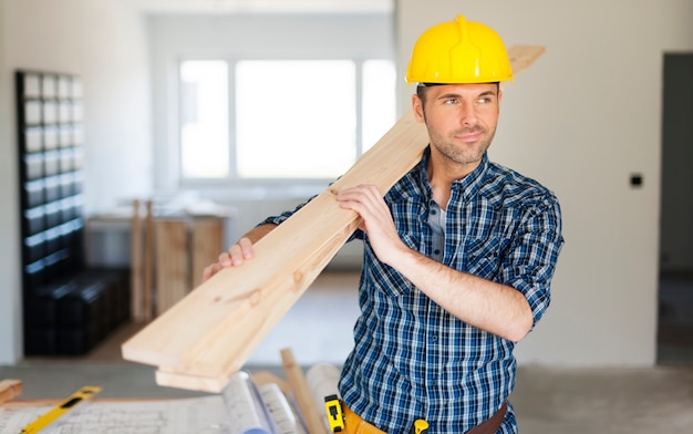 Free Photo | Construction worker holding wood planks