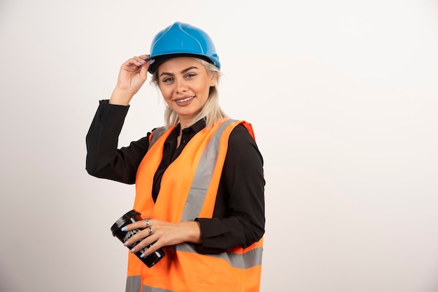 Free Photo | Construction worker posing with cup of tea on white ...