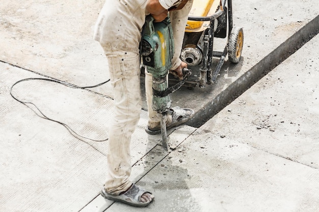 Premium Photo | Construction worker using jackhammer drilling concrete ...