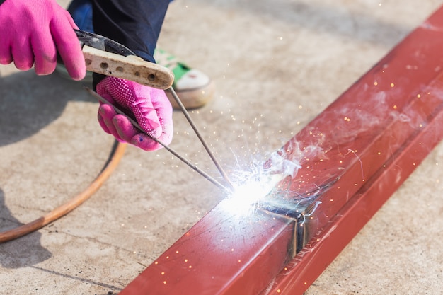 Premium Photo | Construction worker welding steel for roof structure