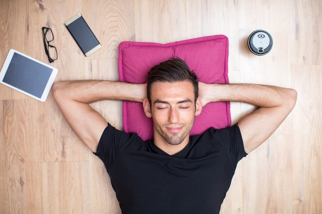 Content handsome man lying on floor and relaxing Free Photo