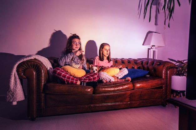 Free Photo | Content kids with dog watching tv