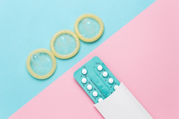 Premium Photo | Contraceptive pills and condoms