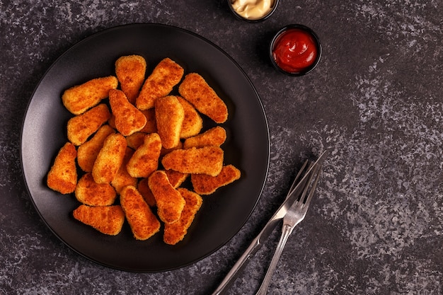 premium-photo-cooked-chicken-nuggets-on-a-plate-with-sauces